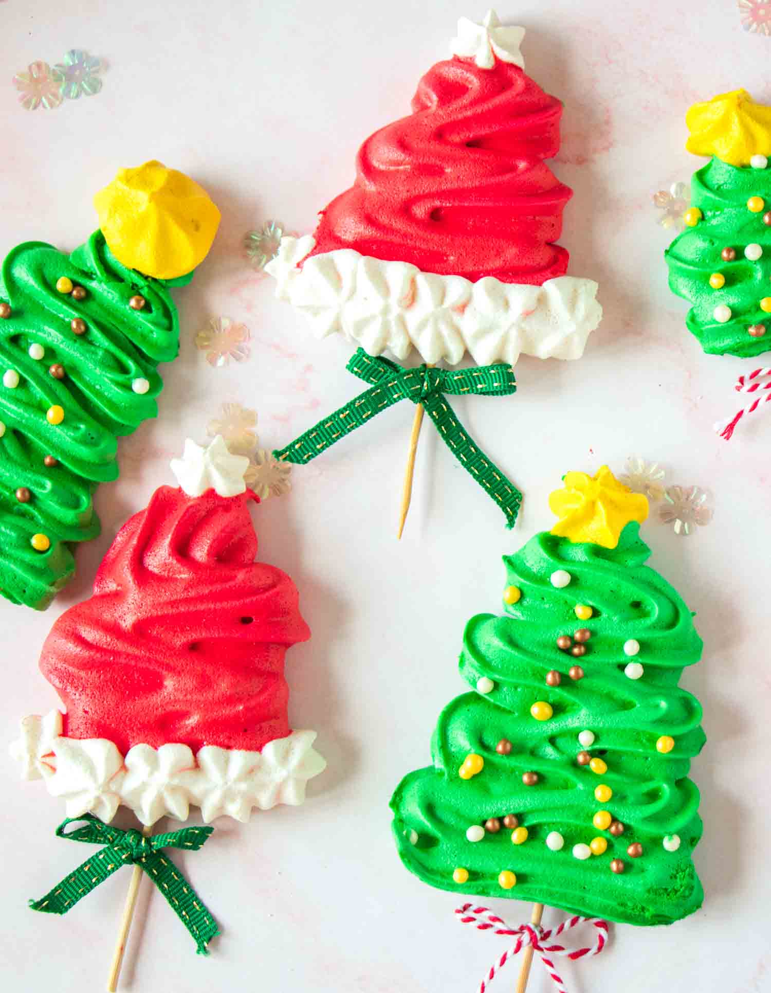 Christmas meringue pops shaped in christmas trees and santa hats