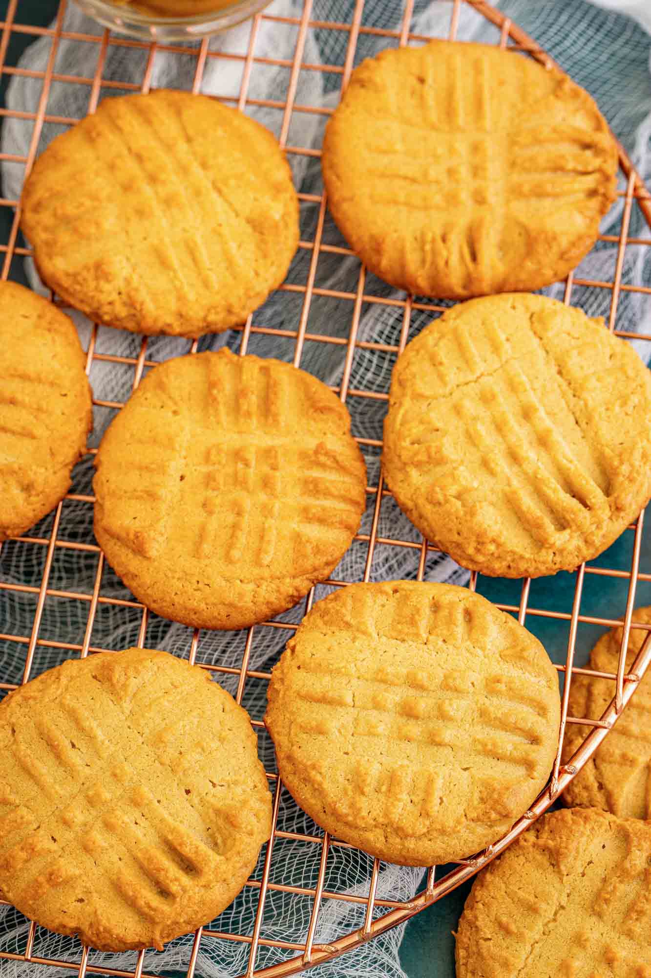 a round wire rack of peanut butter cookies, viewed from above.