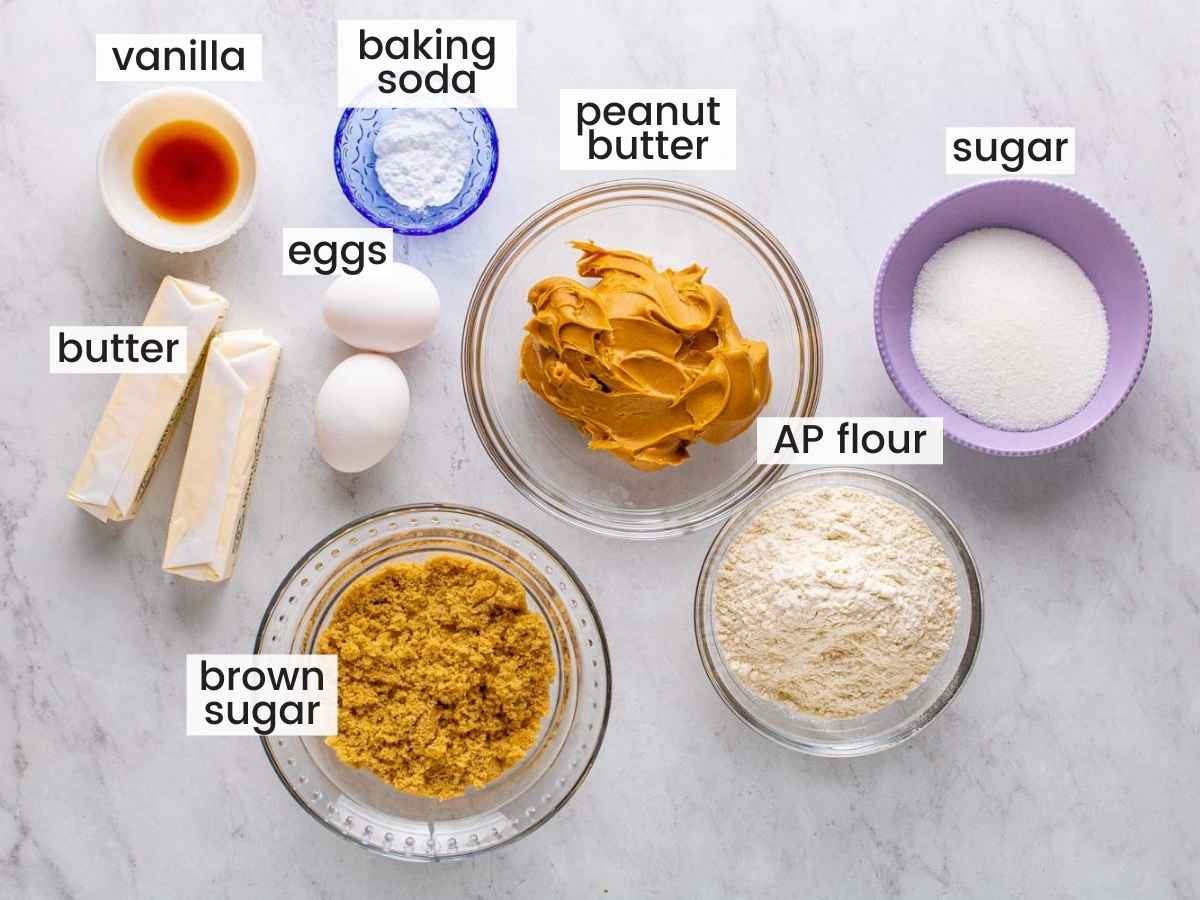 The ingredients for peanut butter cookies measured into separate bowls on a countertop