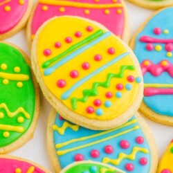 Egg shaped sugar cookies decorated with lines, dots, and squiggles in bright neon colors