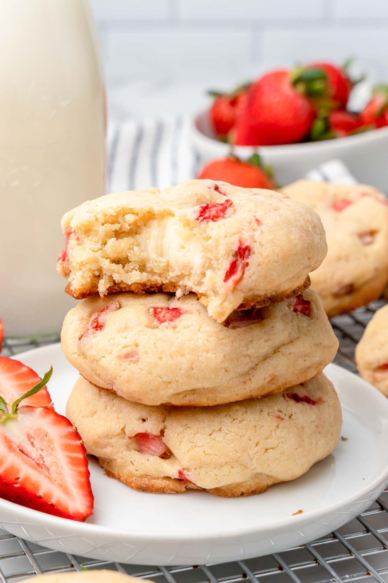 a small plate filled with three stacked cheesecake stuffed strawberry cookies. 