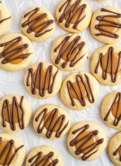 Overhead shot of a bunch of twix thumbprint cookies
