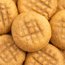 closeup of a tray of peanut butter cookies with cross hatch tops
