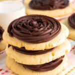 Three large cookies with chocolate frosting swirls, stacked on top of each other