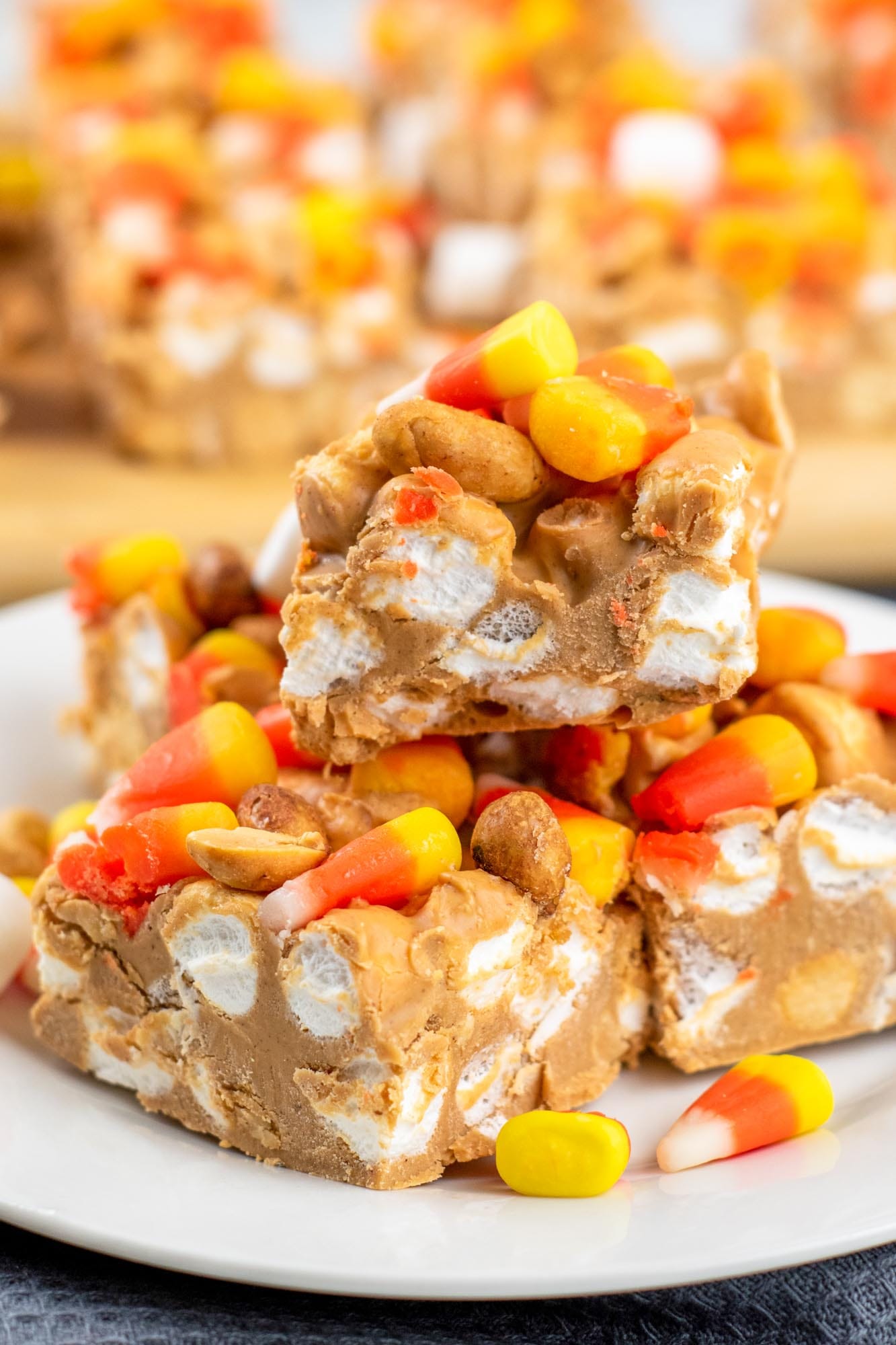 Candy corn marshmallow squares stacked on a plate.