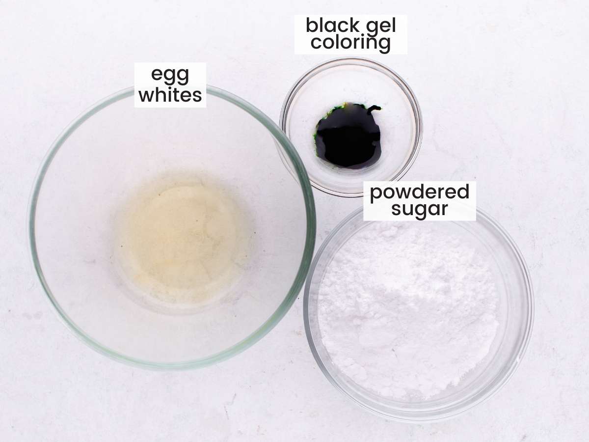 The ingredients for making black royal icing with egg whites