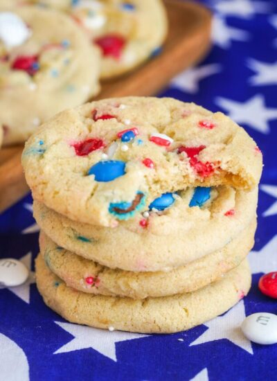 Red white and blue M&M cookies stacked and placed on USA flag