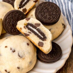 a white plate filled with oreos and oreo stuffed cookies.