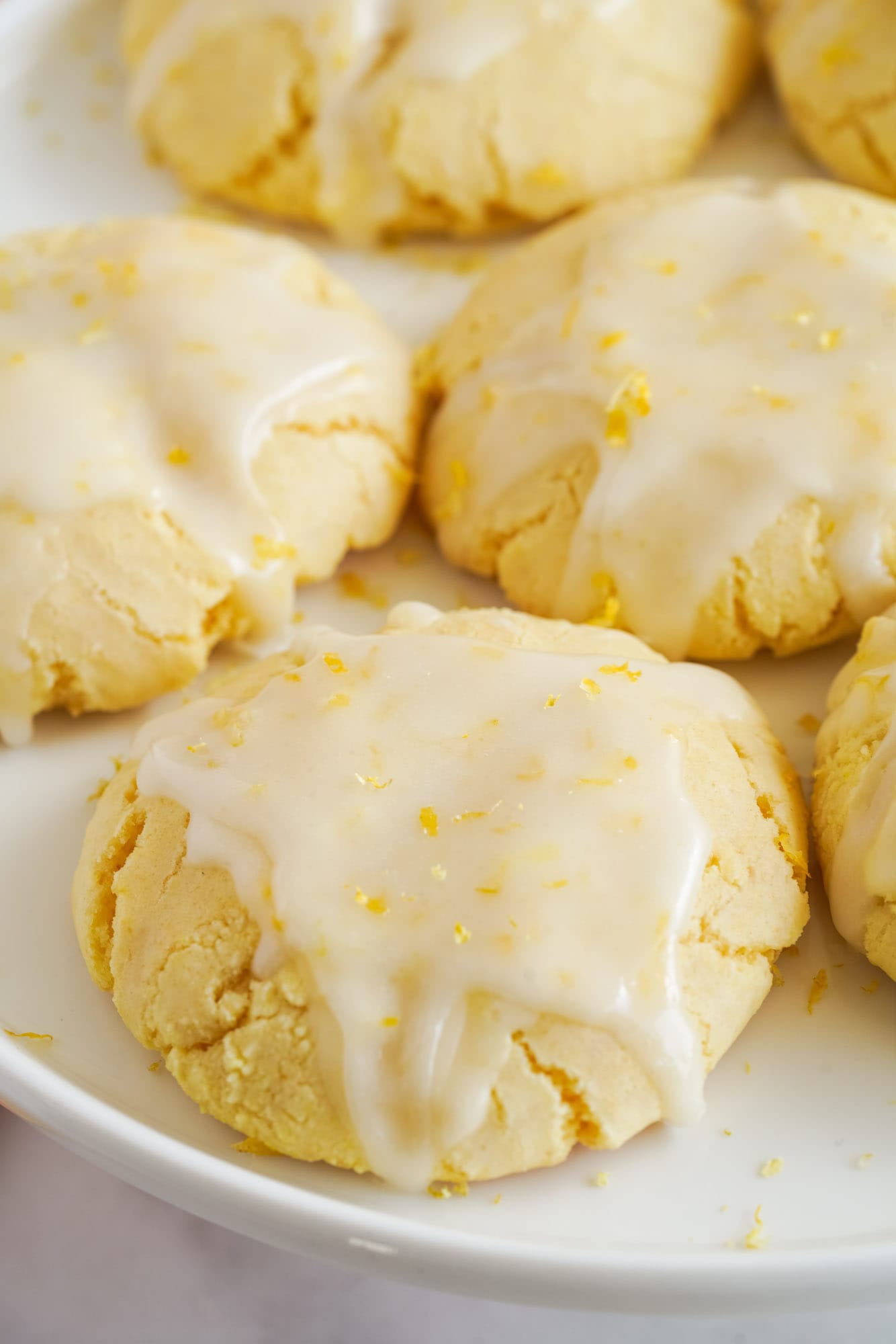 glazed lemon cake mix cookies on a plate, close up view
