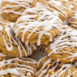 a platter of apple cookies with white drizzled frosting.