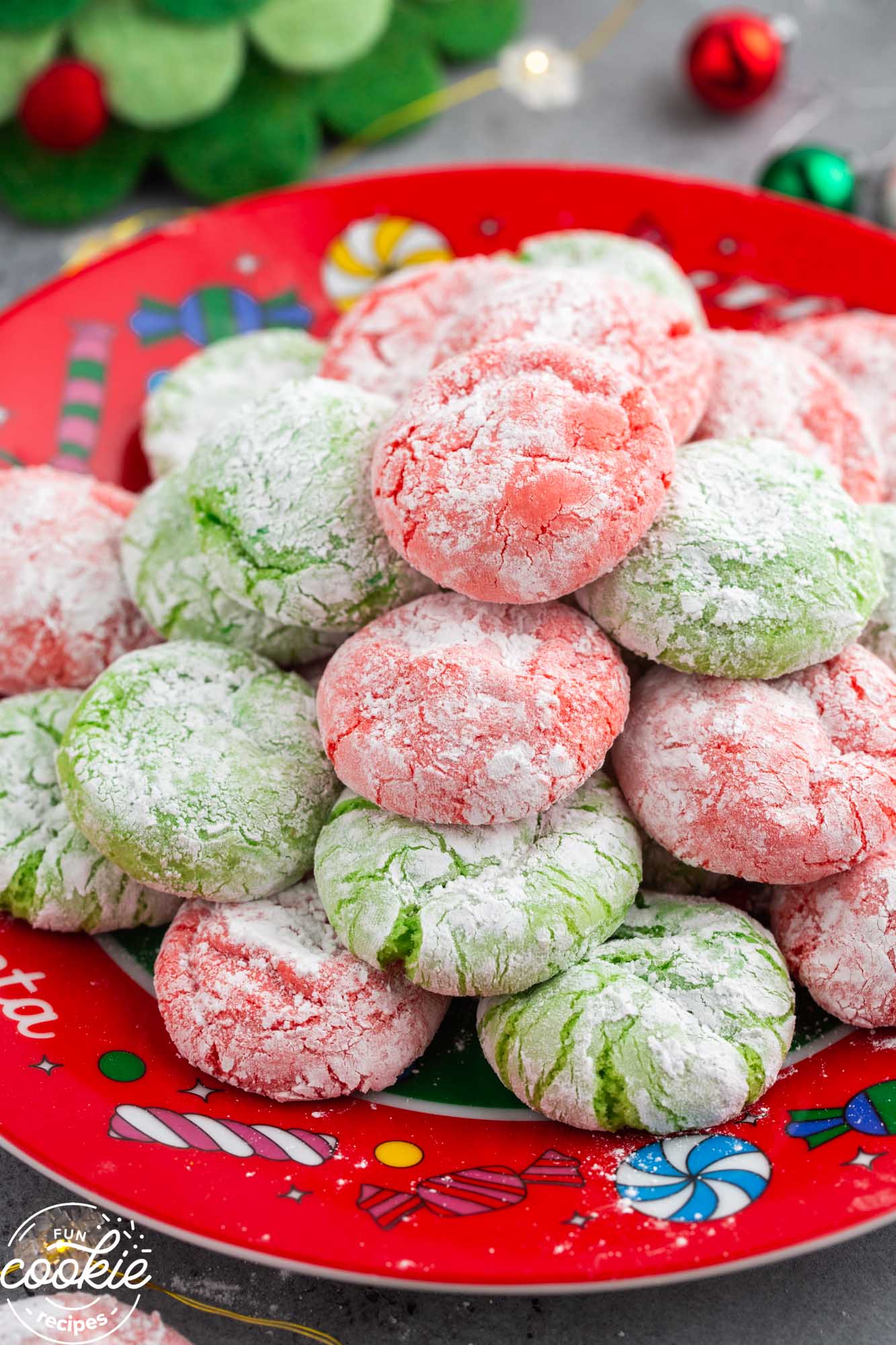 Stacked christmas cake mix crinkle cookies on a holiday themed plate