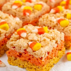 close up of yellow and orange rice krispie treats with candy corn on top