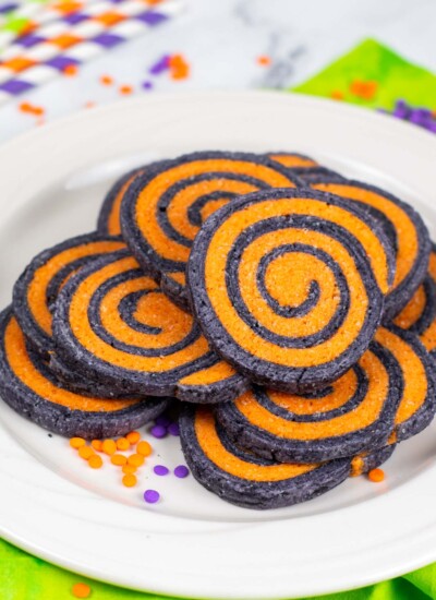 black and orange swirled cookies on a white plate