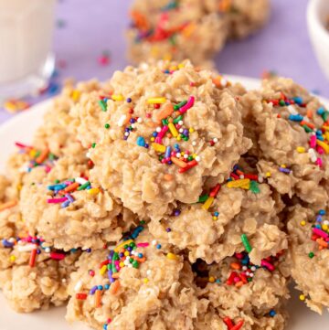 A plate of no bake sugar cookies made with oats and topped with sprinkles.