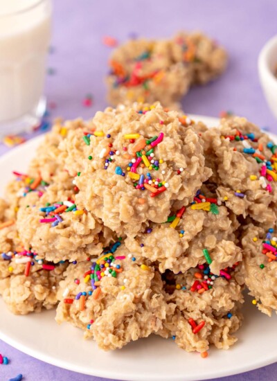 A plate of no bake sugar cookies made with oats and topped with sprinkles.