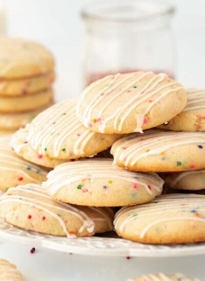 plate of milk cookies stacked on top, sitting on a white plate