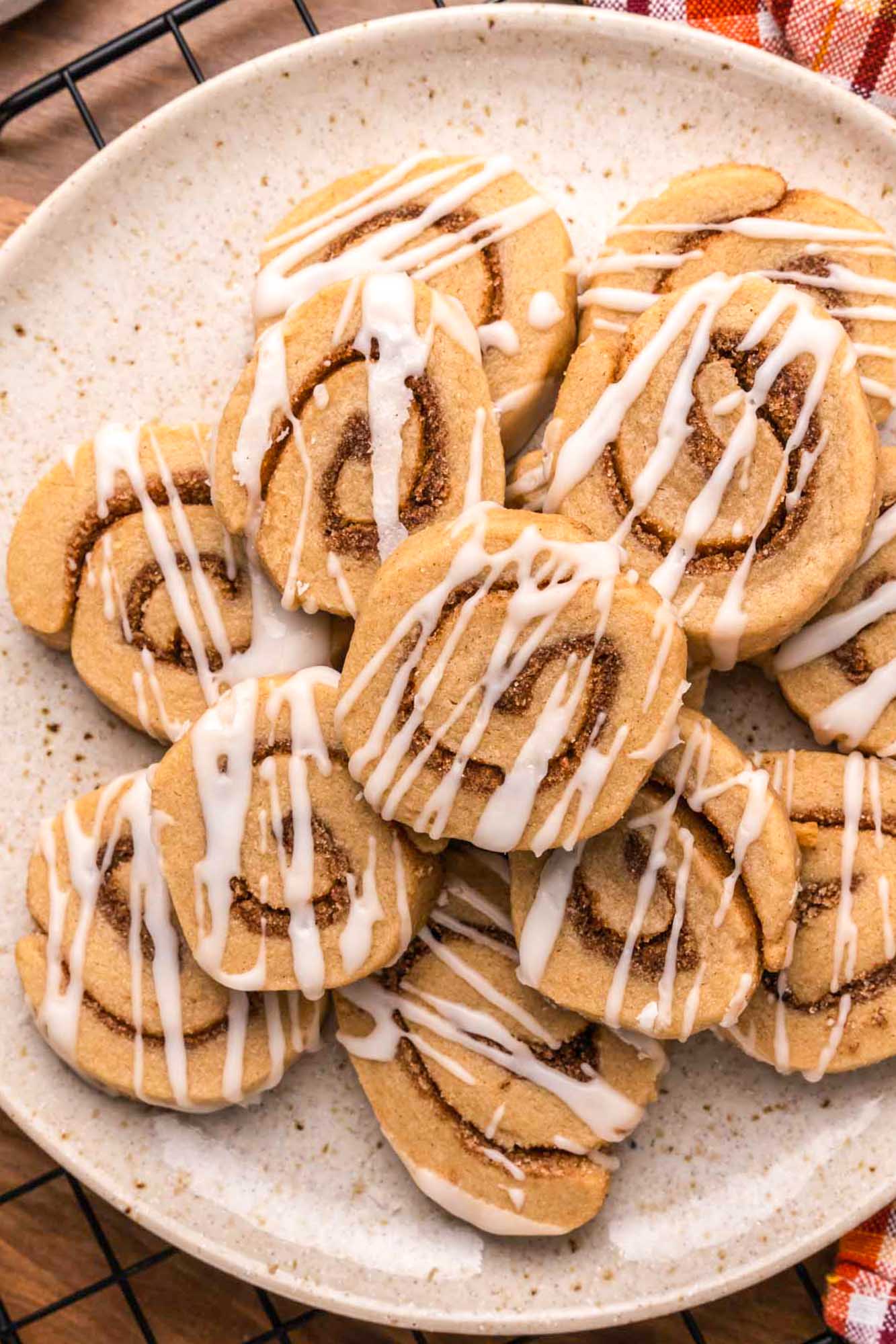 Overhead shot of cinnamon roll cookies, iced with a drizzle of icing