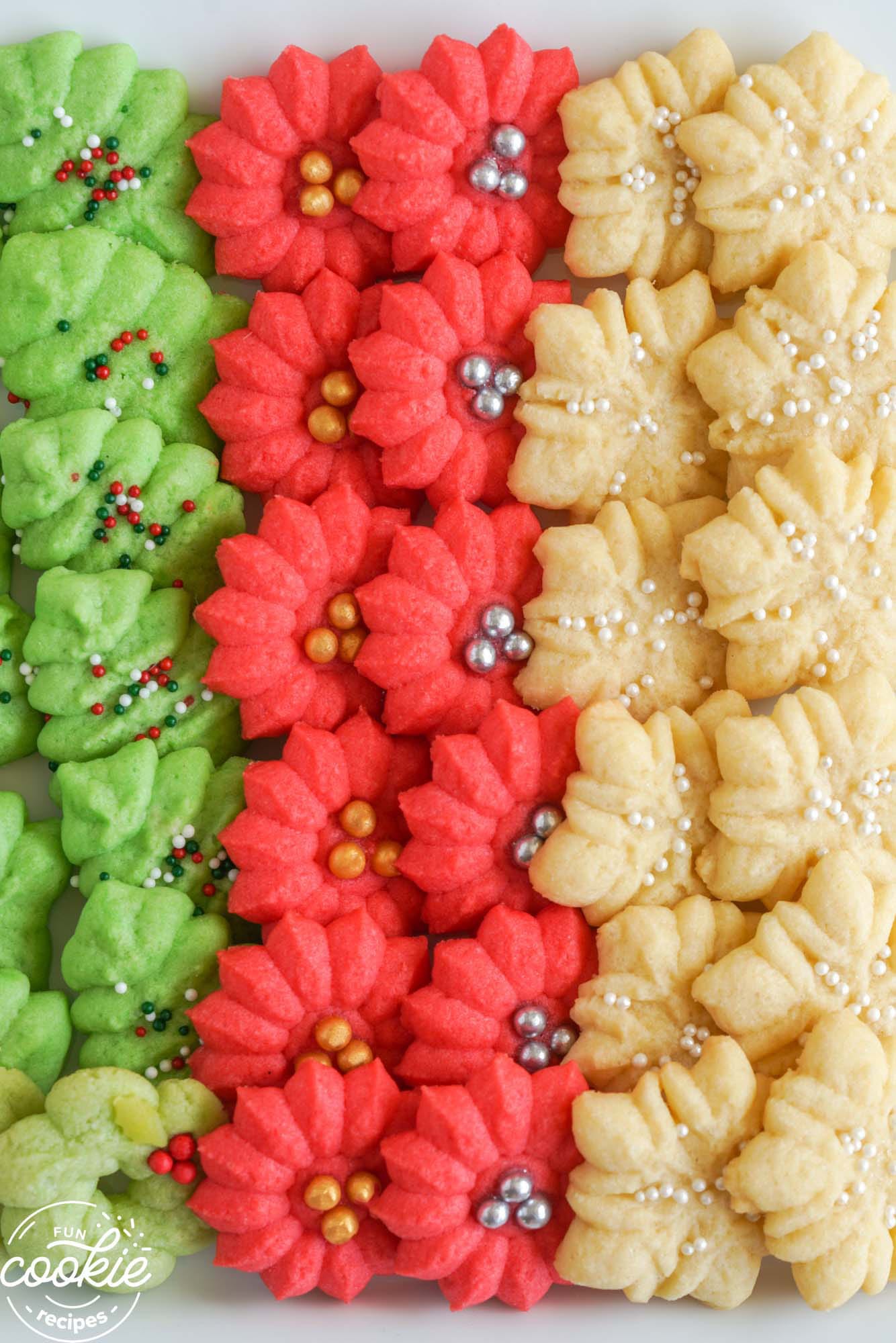 Rows of colorful spritz christmas cookies on a plate - an overhead shot.