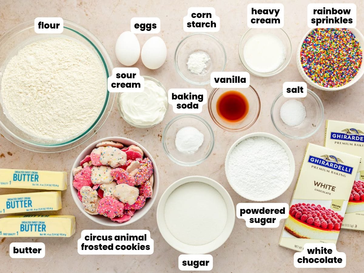The ingredients needed to make circus animal cookie topped sugar cookies, all in separate bowls on a counter. 