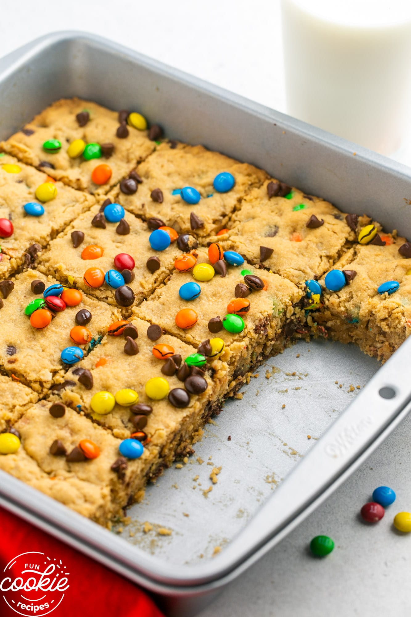 Sliced monster cookie bars in a square pan