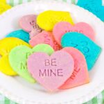 Stamped conversation heart cookies on a white plate