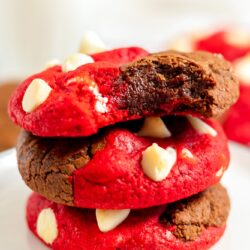 a stack of three red velvet brookies with white chocolate chips.