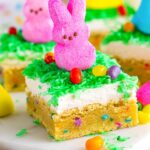 easter sugar cookie bars on a platter, decorated with peeps and jelly beans.