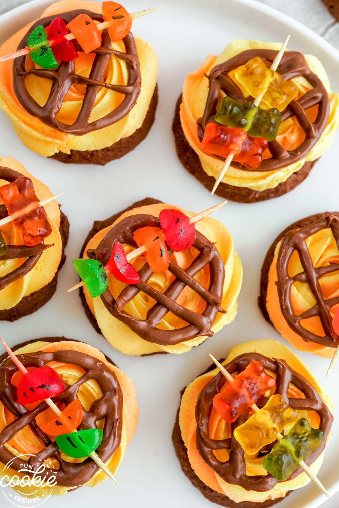 a plate of frosted cookies, decorated to look like grills with kabobs on them. 