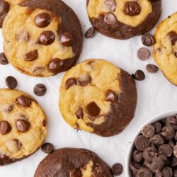 cookies that are half brownies, on a piece of parchment paper, viewed from above.