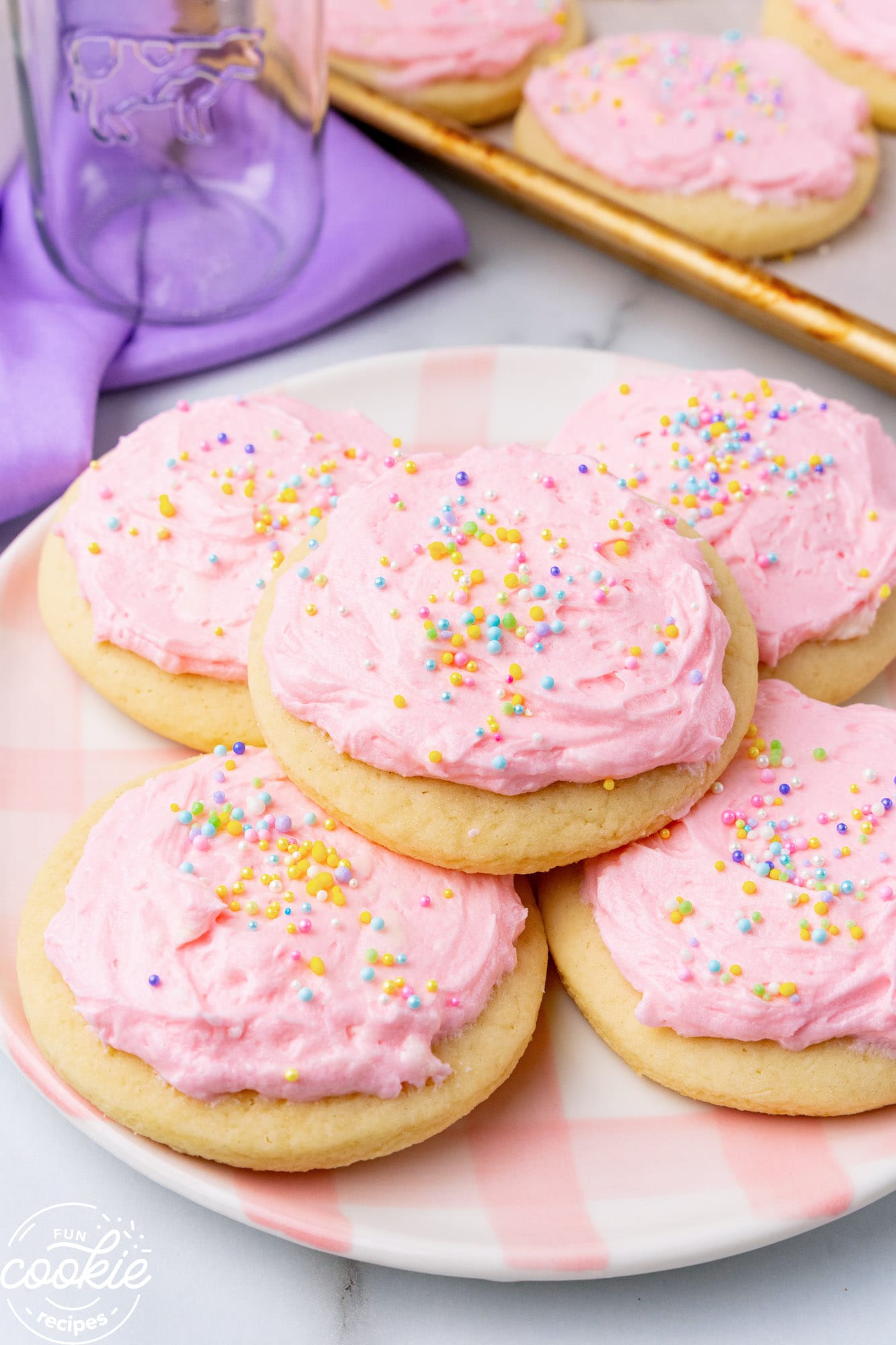 a plate with 5 large lofthouse style sugar cookies on it.