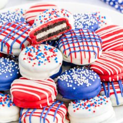 4th of July dipped Oreos in red white and blue, stacked on a white plate