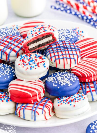 4th of July dipped Oreos in red white and blue, stacked on a white plate