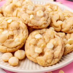 A large plate of macadamia nut cookies with white chocolate chips.