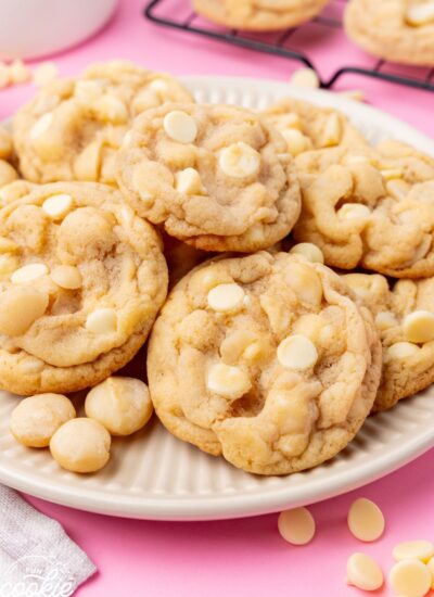 A large plate of macadamia nut cookies with white chocolate chips.