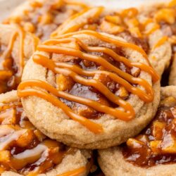 apple pie cookies with apple filling and caramel drizzled on top.