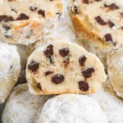 a bowl of snowball cookies. Three are cut in half to review mini chocolate chips inside.