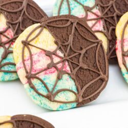 Wednesday & Enid decorated Window Cookies on a white plate