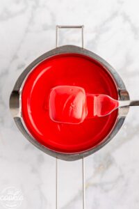 dipped truffle in red candy melts over double boiler