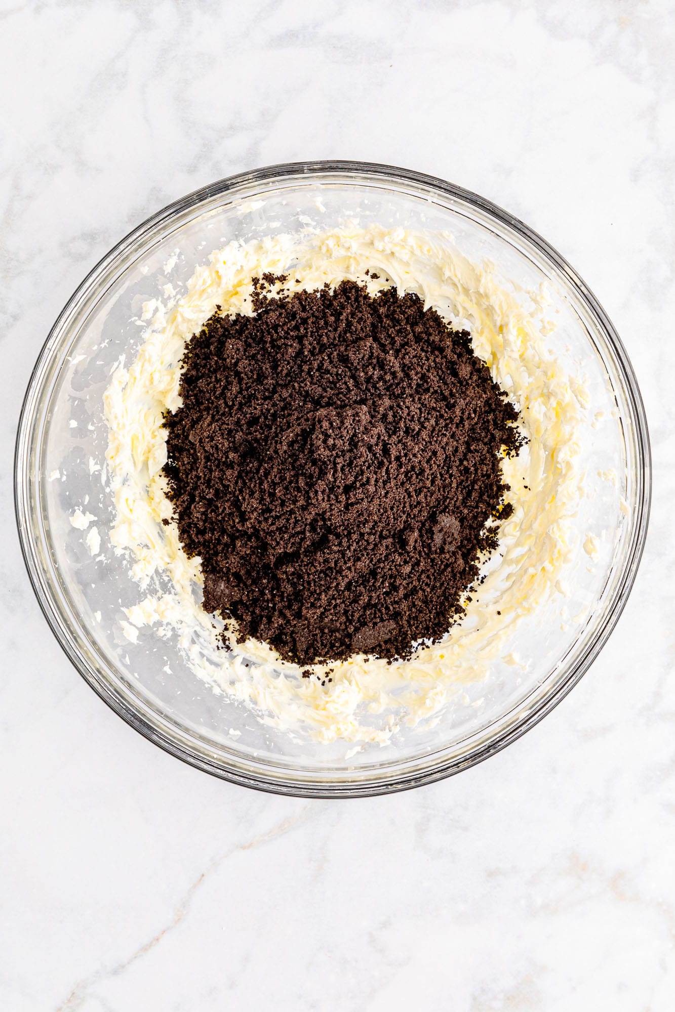 Mixing oreo crumbs with cream cheese