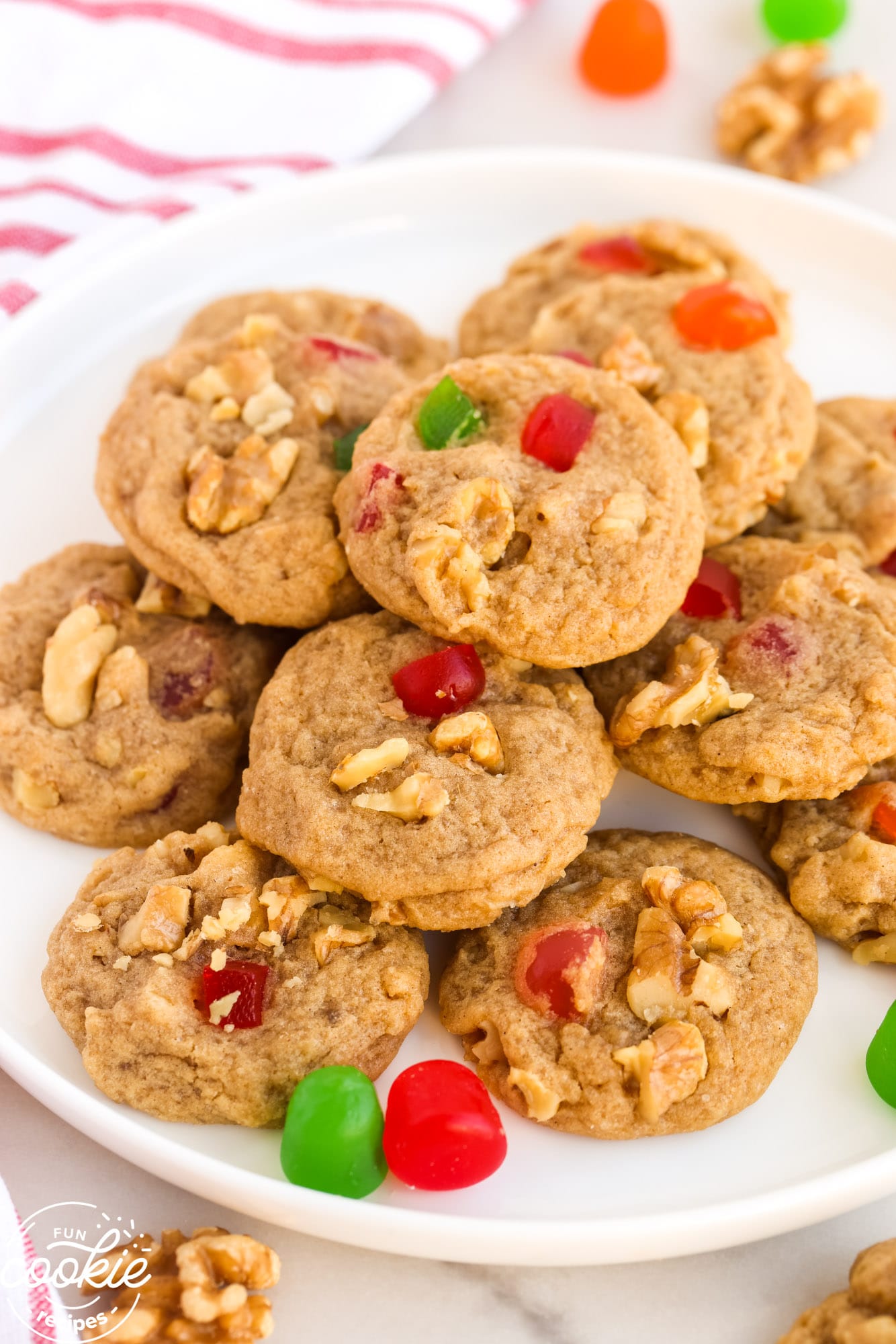 Gumdrop cookies with walnuts stacked on a white plate