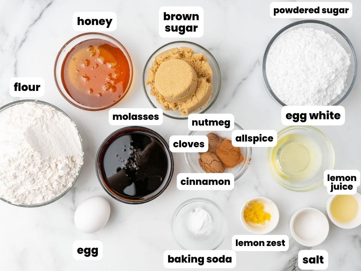 The ingredients needed to make german lebkuchen cookies, including molasses, spices, and honey.
