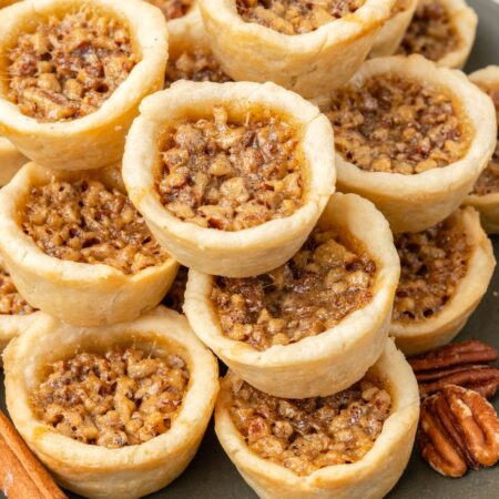 a plate piled with pecan tassies.
