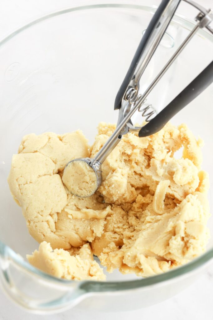 vanilla cookie dough with a cookie scoop.