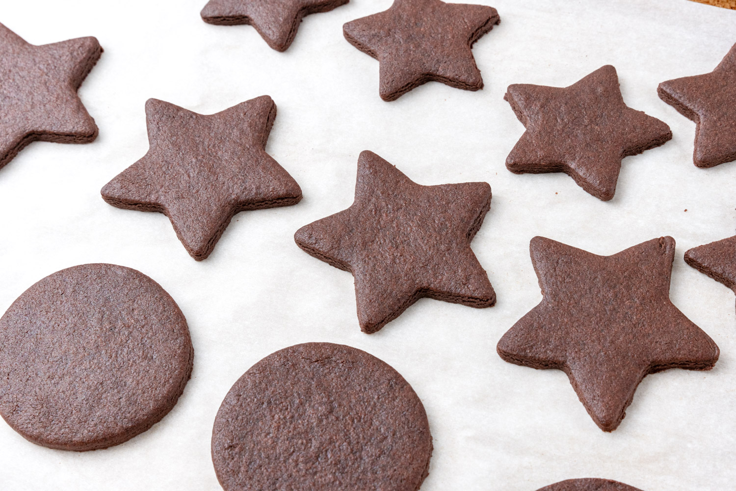 Baked chocolate sugar cookies shaped as stars and circles