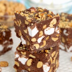 2 stacked pieces of rocky road fudge, with peanuts on the sides