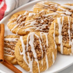 an oval platter of coffee cake cookies with icing. Cinnamon sticks are added for garnish.